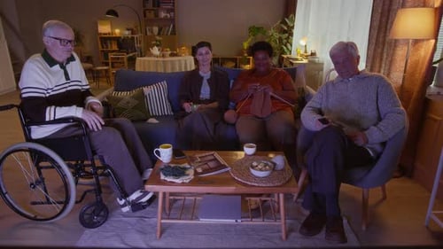 Multiethnic Nursing Home Residents Enjoying Relaxed Evening in front of TV