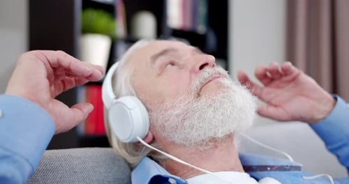 Senior Man Relaxing and Listening to Music