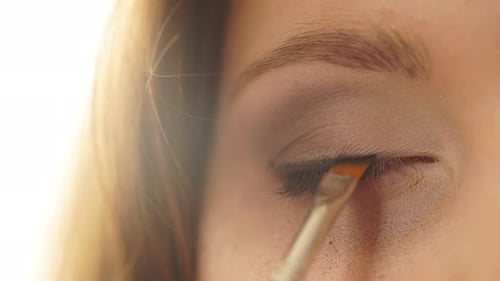 Makeup. Applying Black Eye Liner To Model Eye
