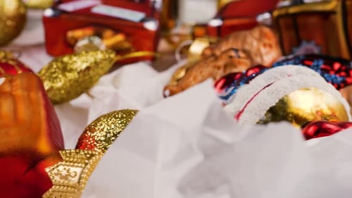 Festive Christmas decorations close-up. Red and gold holiday ornaments.