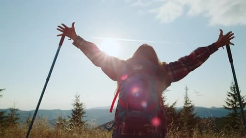 Woman Hiker Reaches Mountain Top With Arms Up