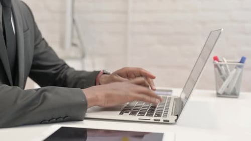 Close up of African Businessman Working on Laptop