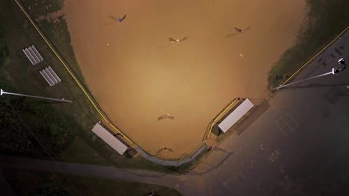 Top View of a Baseball Field at Night with Players Playing American Baseball