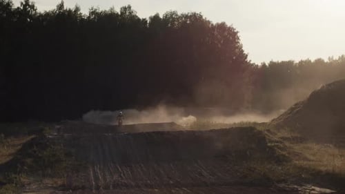 Silhouette of Dirt Bike Racing at Sunrise