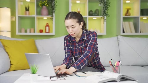 Woman Working on Laptop Computer at Home
