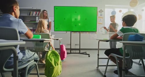 Primary School Boy Showcasing Knowledge Using Digital Screen with Chromakey Mockup