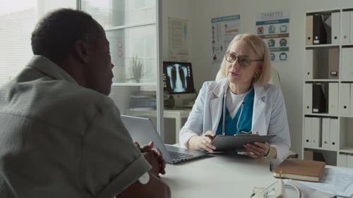 Doctor Consults with Patient in Office