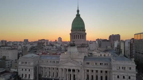 Aerial ascending shot capturing palace of the Argentine National Congress, downtown cityscape and be