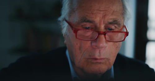 Senior Man Concentrates While Using Computer