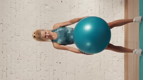 Woman Does Core Workout With Exercise Ball
