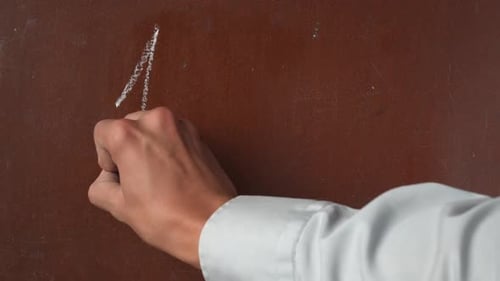 Hand Writes Simple Addition Problem with Chalk