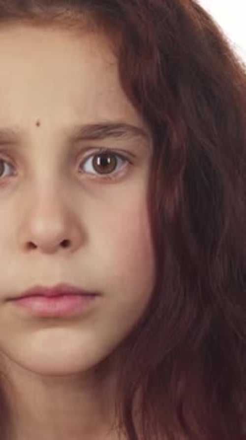 Curious Girl Gestures for Silence with a Playful Expression