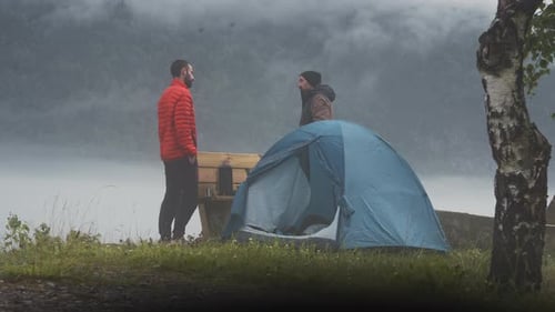 campers setting up a tent in Norway scenic fjord mountain travel destination In north Europe