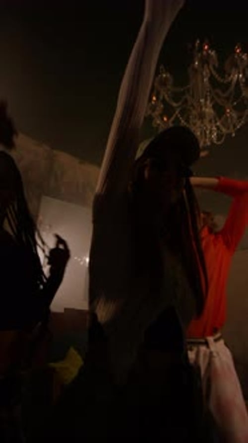 Young Adults Dancing at Indoor Party Under Red Lights