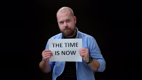 Bearded Man Holds Sign: The Time is Now