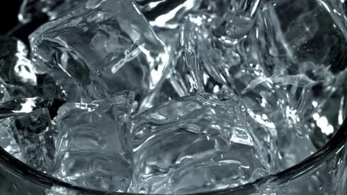 Ice Cubes Fill a Glass with Water