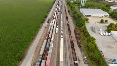 4k aerial view showing multiple trains parked at a train station waiting to leave