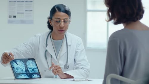 Doctor Explains Brain Scan to Patient on Tablet