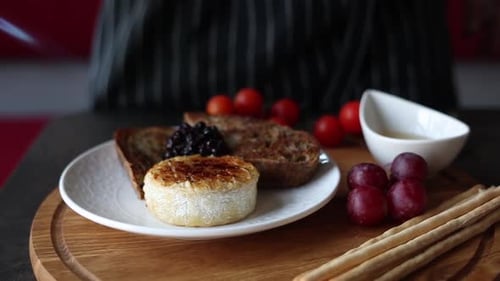 Soft cheese with mold with toast and sauce.