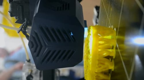 Close Up of 3D Printer Creating Yellow Component