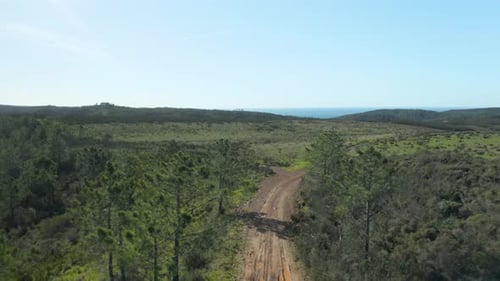 Drone flying back over a dirt road in south of Portugal