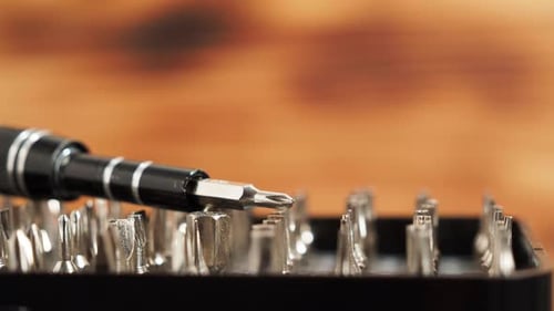 Rotating Universal screwdriver set with different bits. Close-up bit set.