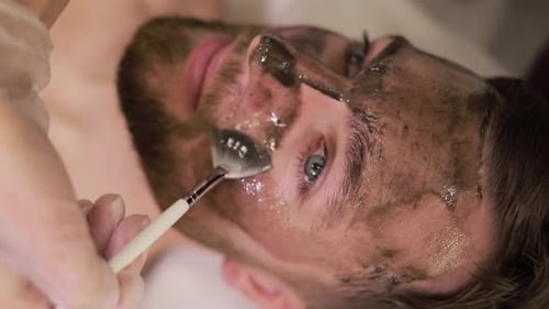 A Man Enjoys a Refreshing Facial Mask at a Luxury Spa for Relaxation and Premium Skin Care
