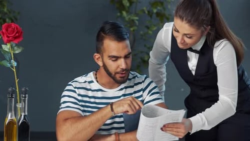 Young Independent Middle Eastern Man Giving Meal Order to Waiter in Cafe