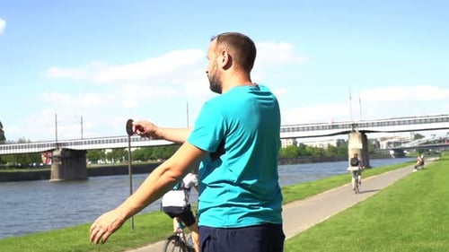 Man Warming Up in City by the River,