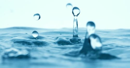 Rain water drops falling in super slow motion.