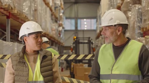 Coworkers Chatting during Shift at Warehouse