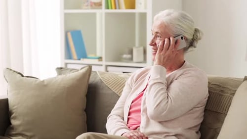 Smiling Senior Woman Talking on Smartphone at Home