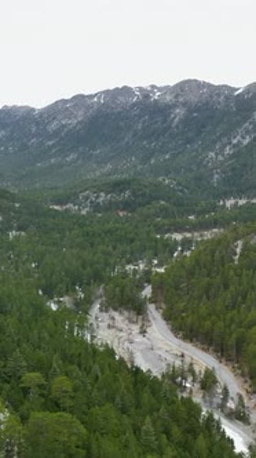 Vertical Video Aerial Winter Escape in Turkish Mountains Majestic Peaks River and Cinematic