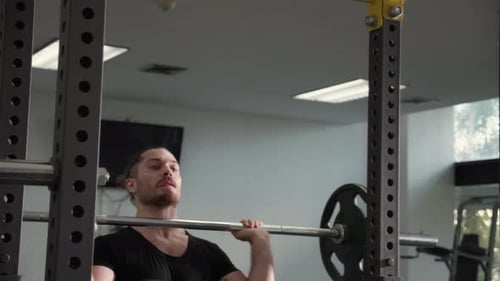 Young caucasian man work out in fitness gym with motivation and determination.