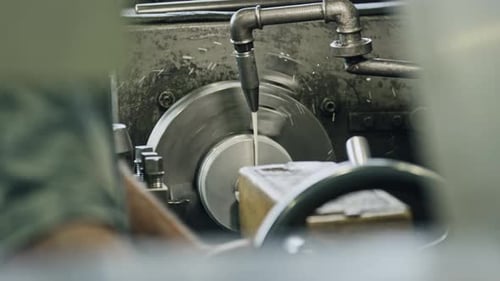 Expert machinist using lathe machine for precise metalwork in industrial setting