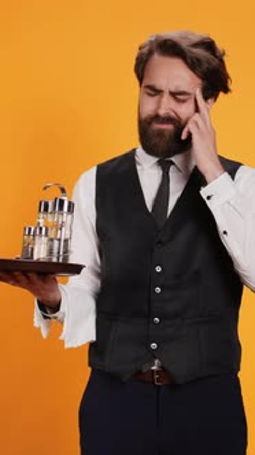 Vertical Video Unhappy Butler Deals with Migraine