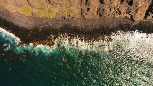 Ocean Waves Break on Stone Rocky Shore