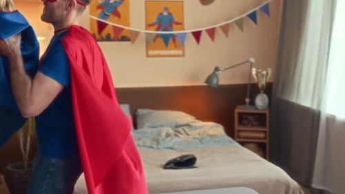 Superhero Father and Child Playing in Room