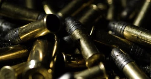 Pile Of Shiny .22 Long Rifle Bullets. Caliber Rimfire Ammunition. closeup shot