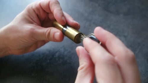 Locksmith Showing How a Key Interacts with a Lock Cylinder Mechanism