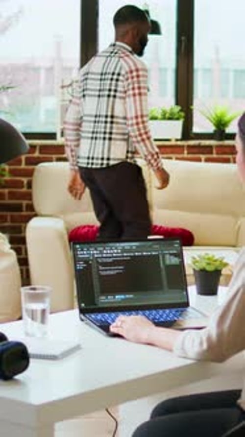Vertical Video Asian Freelancer Woman Works on Programming Code in a Modern Office