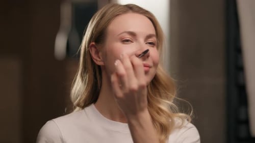 Woman Styling Eyebrows with Brush in Bathroom