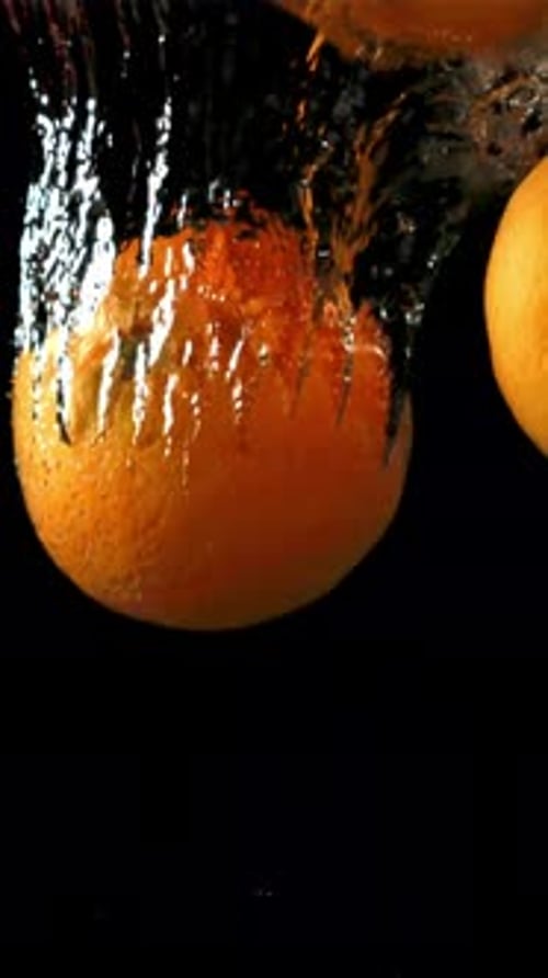Oranges Fall Under Water Filmed is Slow Motion 1000 Fps