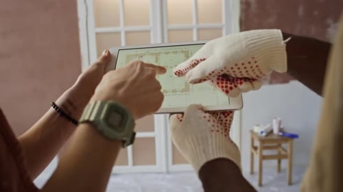 Reviewing Renovation Plans on Digital Tablet
