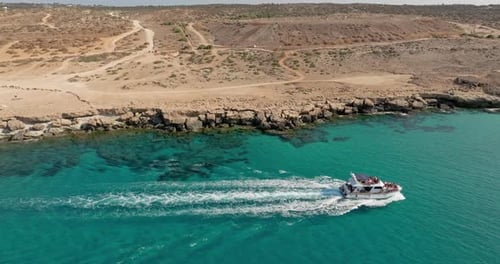Aerial View Luxury Boat Sailing on the Turquoise Water of the Sea Near the Rocks