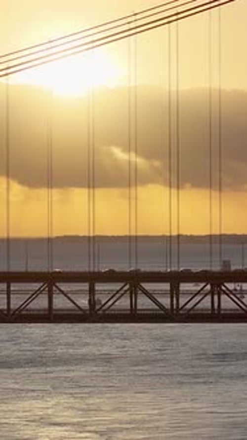 Sunset sky over 25 of April Bridge at Lisbon in Lisbon District Portugal.