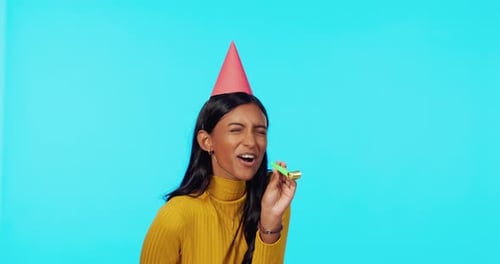 Party, birthday and woman in celebration feeling happy and excited isolated in a blue studio