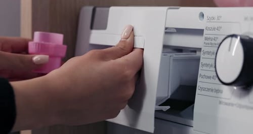 Woman Opens Washing Machine Drawer Close Up