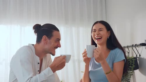 Cheerful Couple Drinking Coffee and Laughing Together