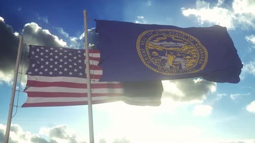 The Nebraska state flags waving along with the national flag of the United States of America